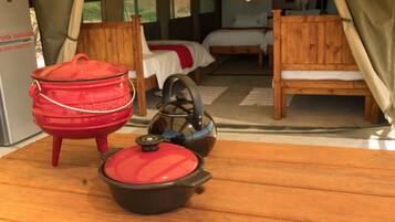Relax in a rustic retreat with a comfortable bed, wooden chair, and cozy table.