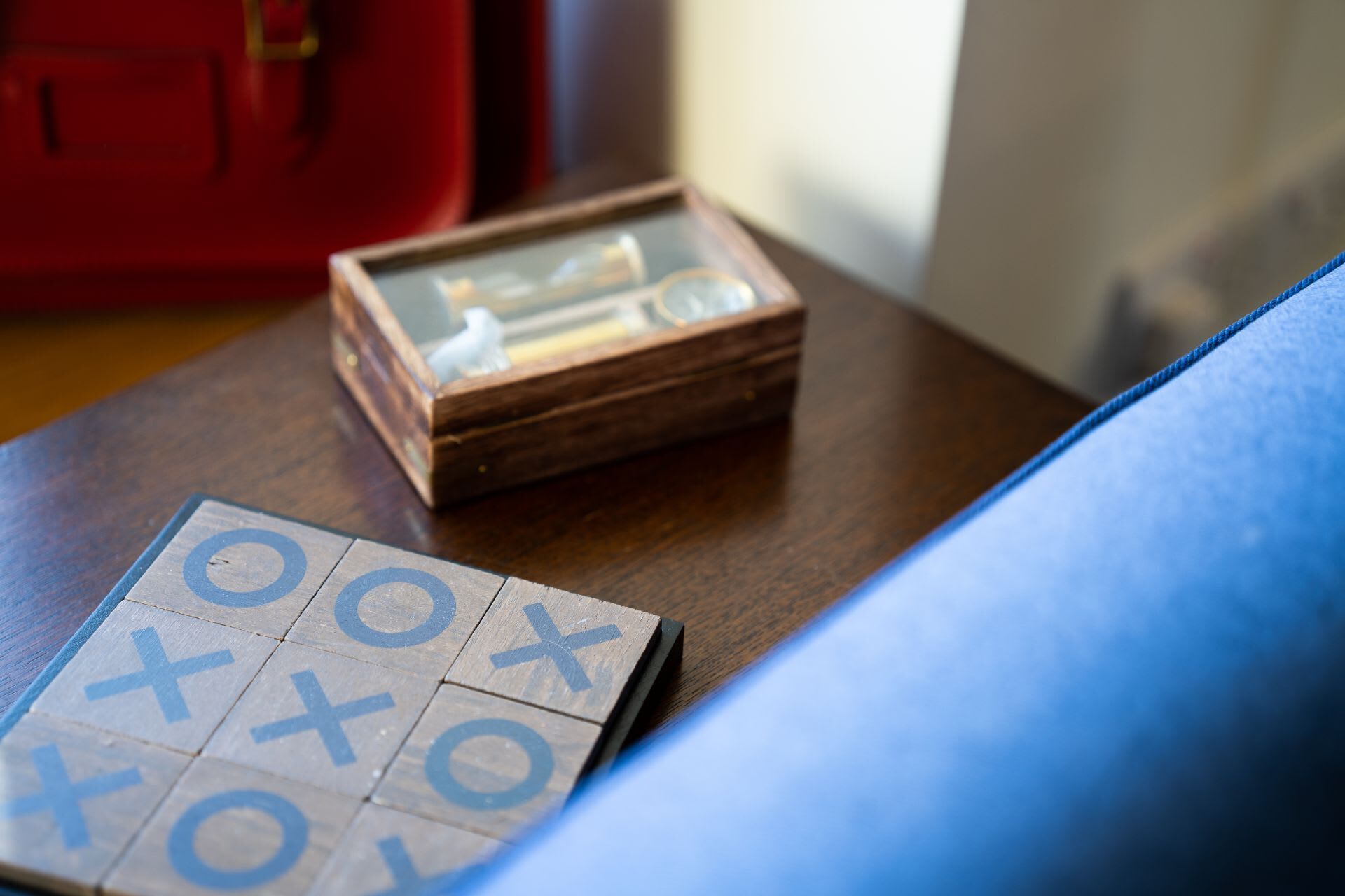 A wooden box with a glass lid on a wooden table.