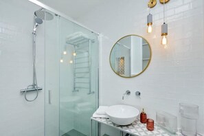 Shower, hair dryer, towels, toilet paper
