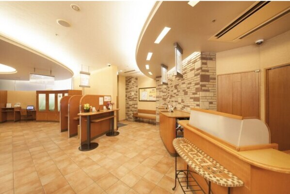 Relax in a spacious interior with multiple seating areas, a reception desk, and a bar.