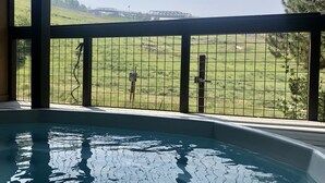 A pool area with a view of a fenced field and industrial structures in the background. - Remodeled 1-Bdrm Ski-In/-Out Condo w/ Fireplace! (Steamboat Springs)