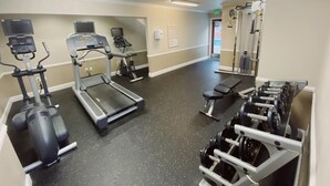 A gym with treadmills, ellipticals, and weight machines.