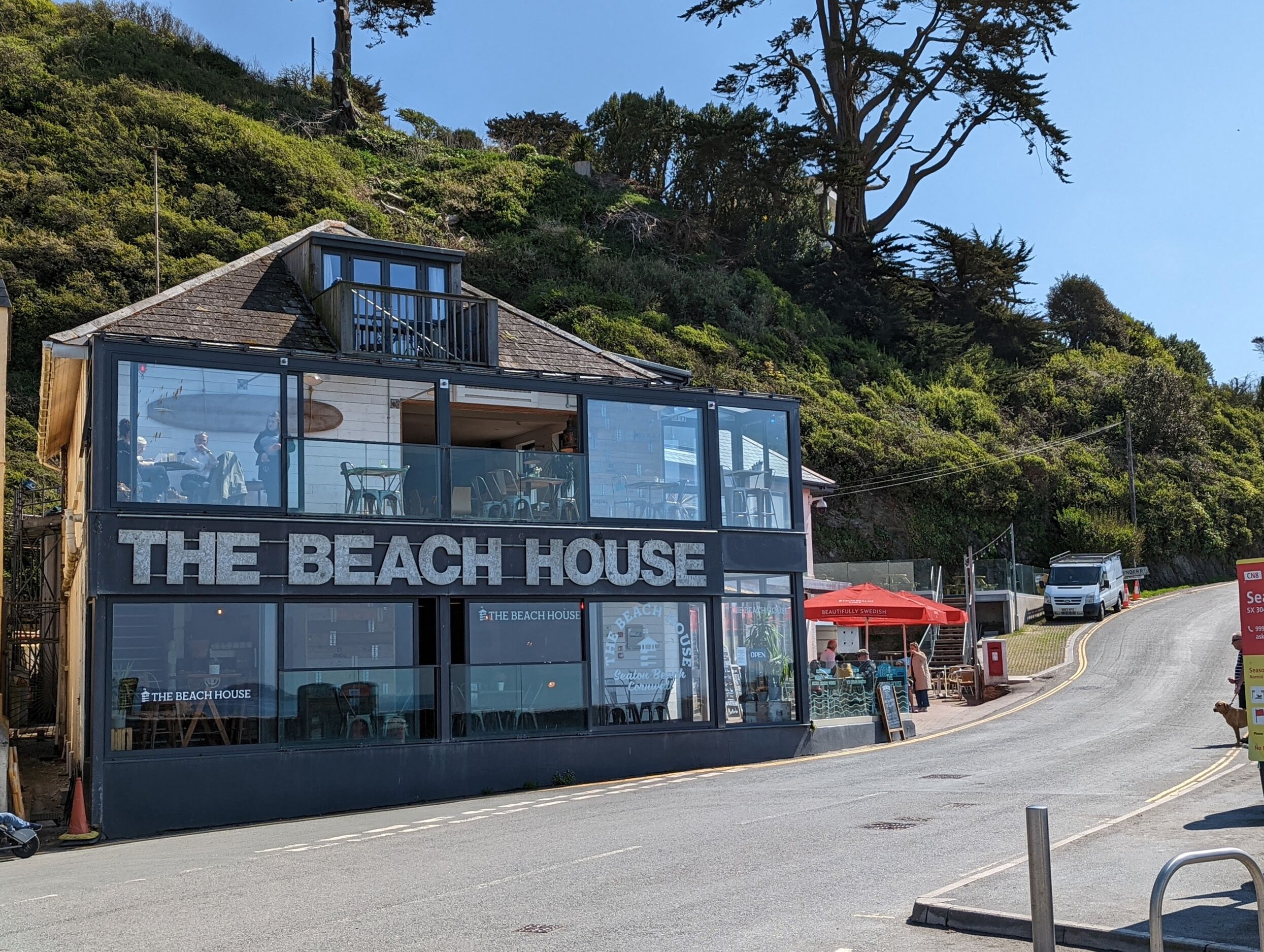 A two-story building with a sign reading "The Beach House."