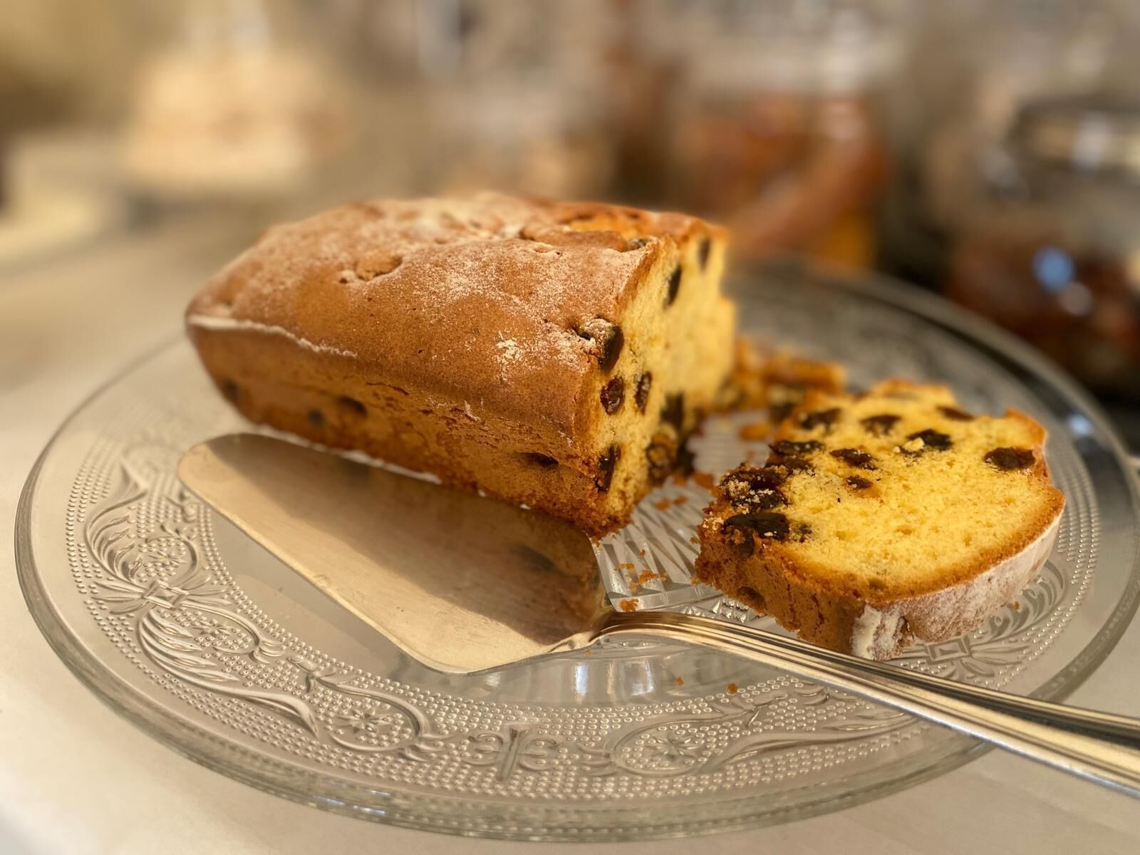 Une part de gâteau aux fruits sur une assiette en verre décorative.