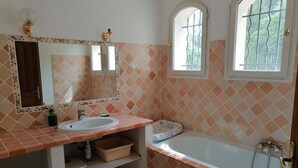 A bathroom with a sink, mirror, window, and bathtub. - Pretty villa on a hill on the edge of the forest (La Crau)