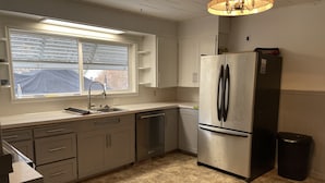 A compact kitchen with a stainless steel refrigerator, a sink, and a window with blinds. - Cozy 2+bed/1bath in quiet neighborhood (Pomeroy)