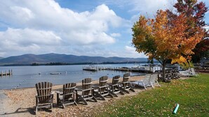 A lakeside view with wooden chairs and a dock. - Lake George House with Beautiful Lake Views and Lake Access 6 Bedrooms 14 People (Lake George)