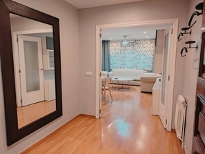 Relax in a comfortable living space with a sofa, dining table, and radiator for a cozy atmosphere.