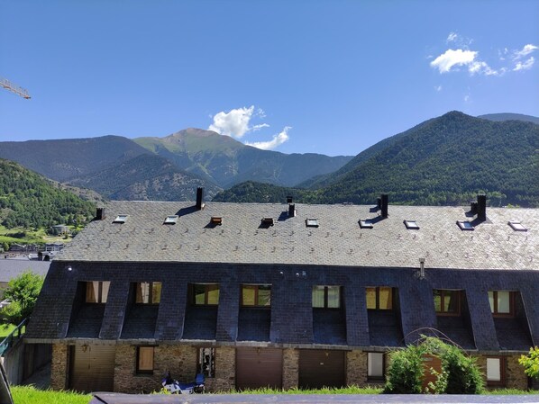 Situated in a scenic valley, this building features a unique sloped roof with multiple skylights.