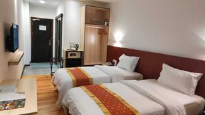 A hotel room with two beds, a desk, a wardrobe, and a television. - Sentral View Hotel (Bintulu)