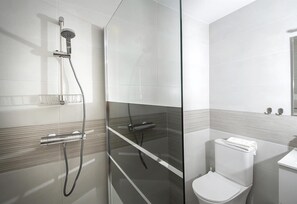 A modern bathroom with a glass shower enclosure, a toilet, and a sink. - Holiday Apartment "Casa Chana" with Terrace, Shared Pool and Jacuzzi (Almunecar)