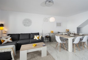 A modern apartment with a living room, dining area, and kitchen. - Holiday Apartment "Casa Chana" with Terrace, Shared Pool and Jacuzzi (Almunecar)