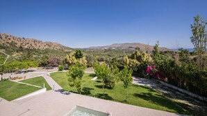 A pool area with a view of a hilly landscape.