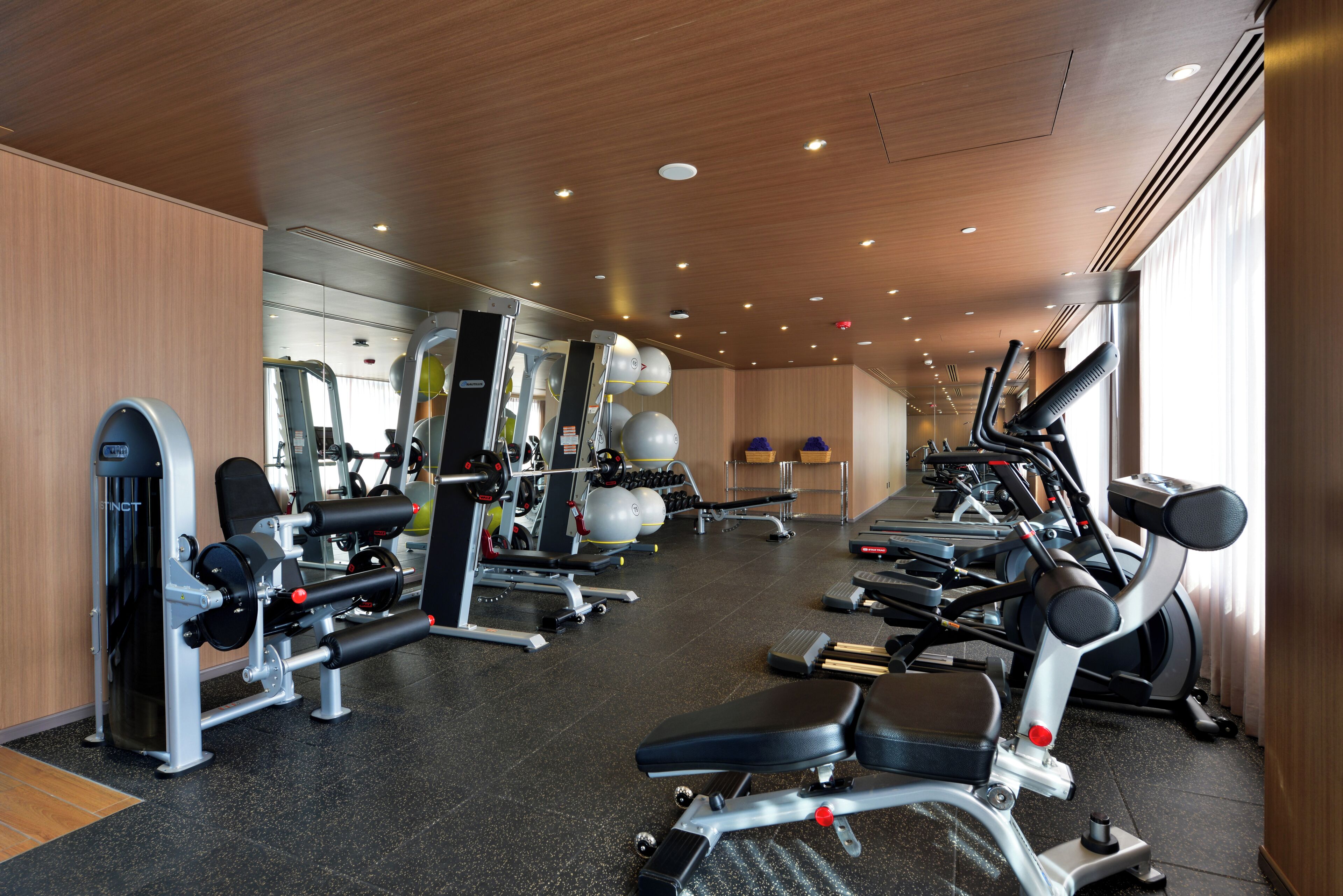 A gym with various exercise equipment, including treadmills and weight machines.