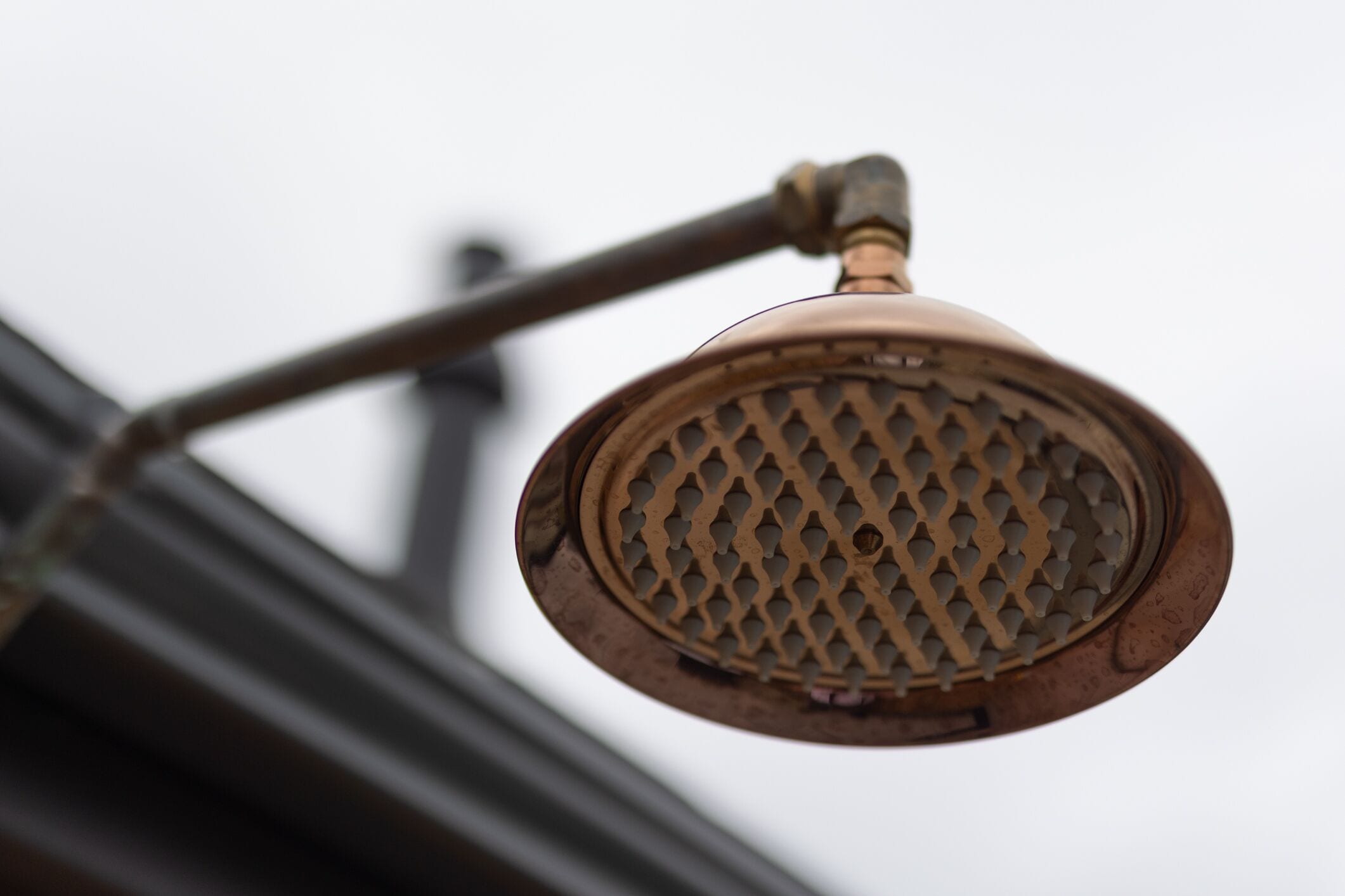 A close-up of a metal grate with a lattice design, attached to a curved metal structure.