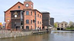 A brick building with a clock tower, labeled "The Old Brewery," located by a canal. - Central Wigan Welcoming Townhouse Sleeps up to 6 (Wigan)