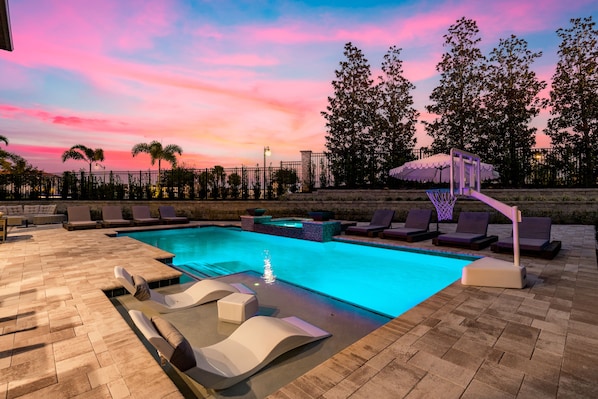 A heated pool, sun loungers