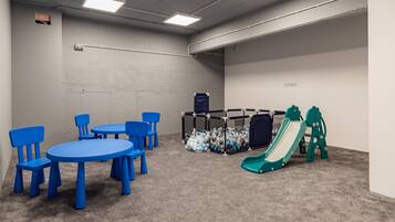 Children can play safely in this play area with a slide and ball pit.