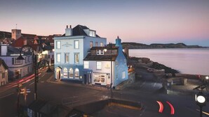A coastal town with a prominent building labeled "The Rock Point Inn." - Rock Point Inn (Lyme Regis)