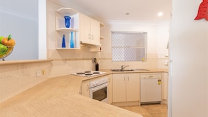Enjoy cooking in this well-equipped kitchen with oven, dishwasher, and ample counter space.