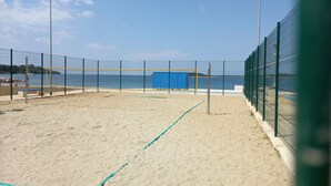 A beach volleyball court with a net, surrounded by a fence, and overlooking the sea. - 2 bedroom apartment in village Valbandon, 1 km distance from the beach (Fažana)