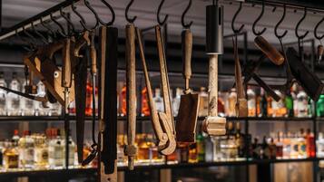 A variety of kitchen utensils hanging on hooks.