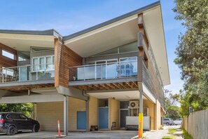 A modern two-story building with a flat roof, large windows, and a balcony. - Beach Baby (Aireys Inlet)