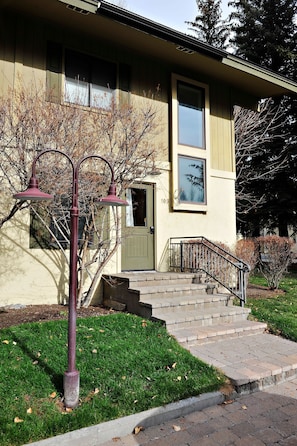 Stunning two-story residence with a charming entrance and beautifully manicured lawn.