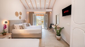 A modern hotel room with a large bed, a desk, a TV, and a balcony with a view. - Korina Apart Hotel (Corfu)