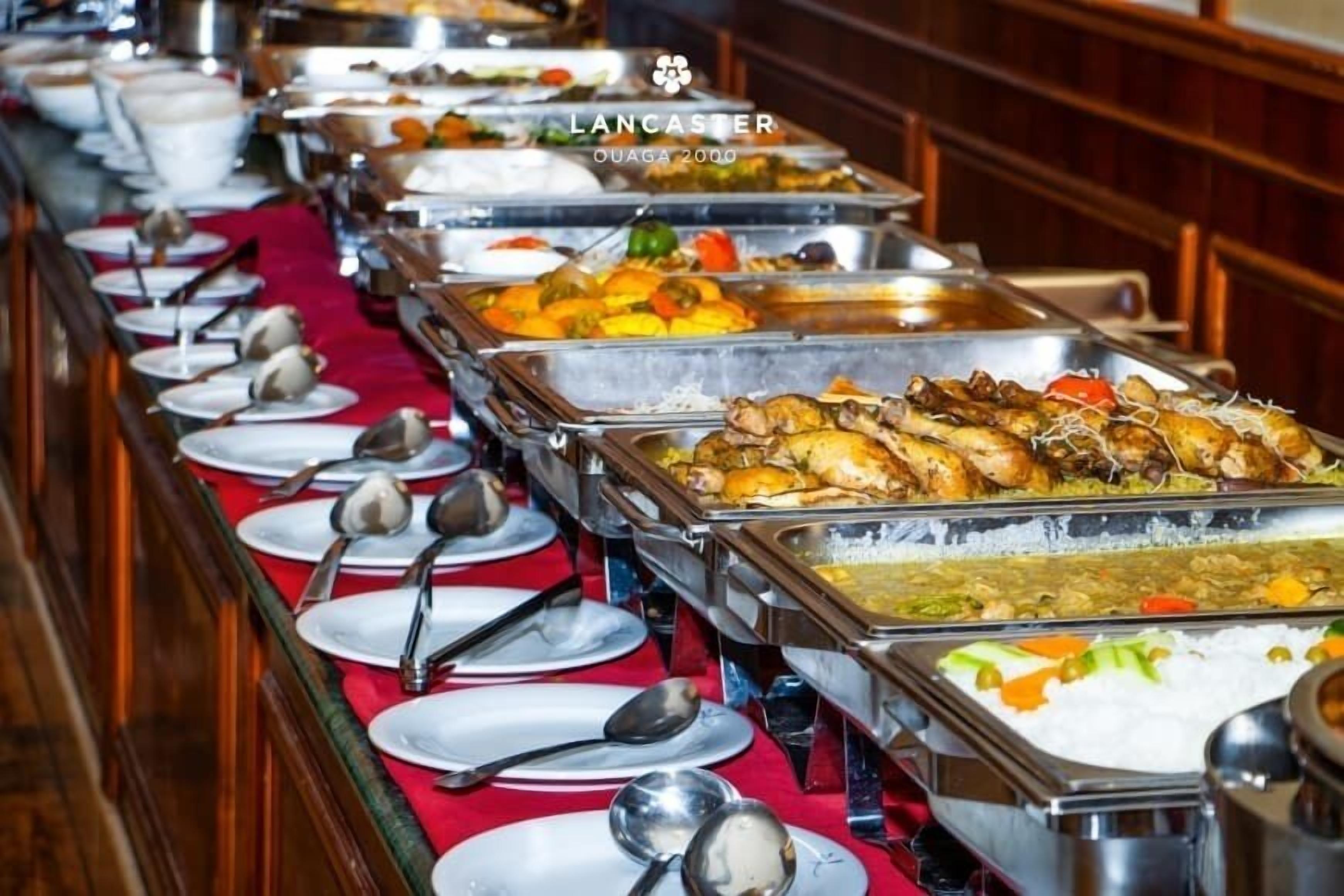 A buffet with various dishes and utensils.