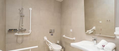 A modern bathroom with a toilet, sink, and shower.
