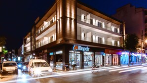 A multi-story building with a repair shop on the ground floor.