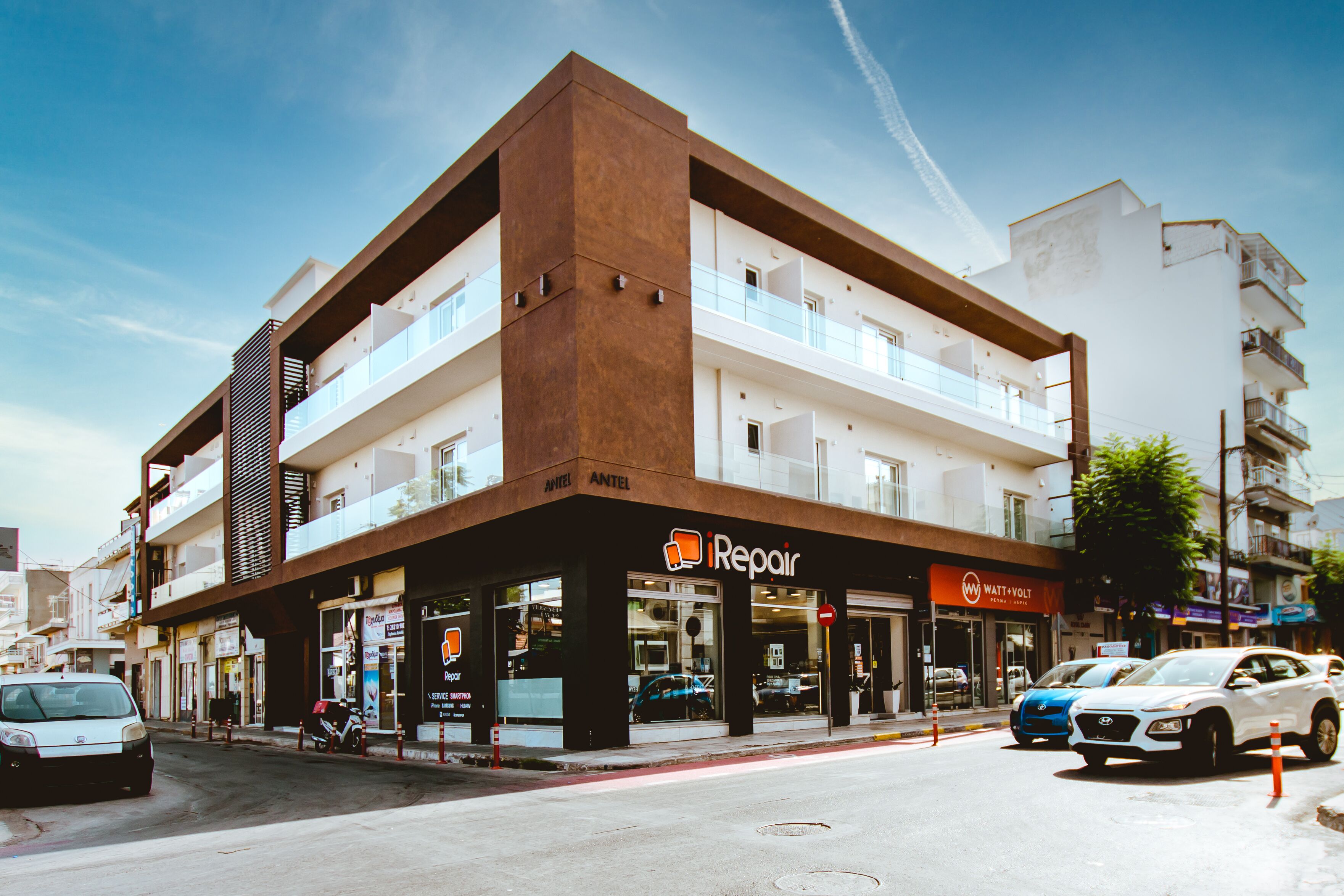 A multi-story building with a repair shop on the ground floor.