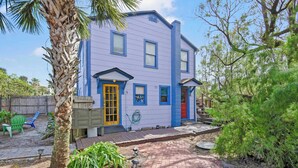 A two-story house with a blue exterior, a yellow door, and a red door. - Marvelous Mermaid Beach Bungalow, Dog-Friendly (St. Augustine)