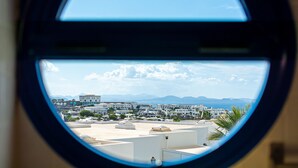 A view from an airplane window of a coastal city with white buildings and a clear sky. - 3BR Home - Private Heated Pool - Parking (Playa Blanca)