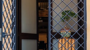 Een traditionele Japanse kamer met tatami vloeren, een shoji schuifdeur en een potplant.