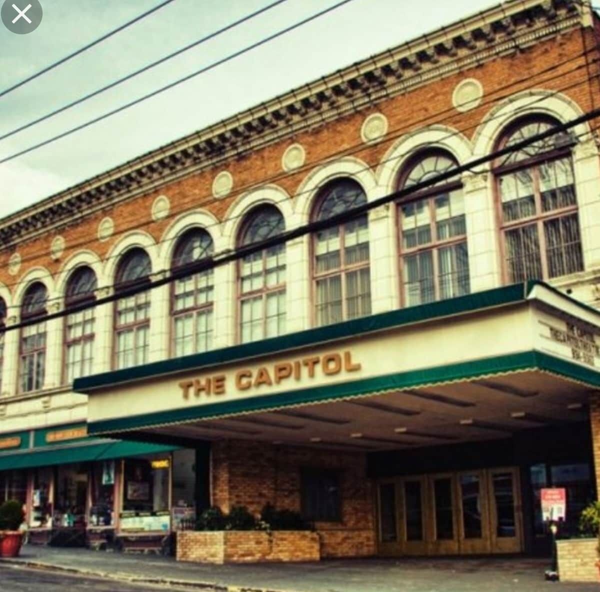 A building with a sign reading "THE CAPITOL" on the facade.