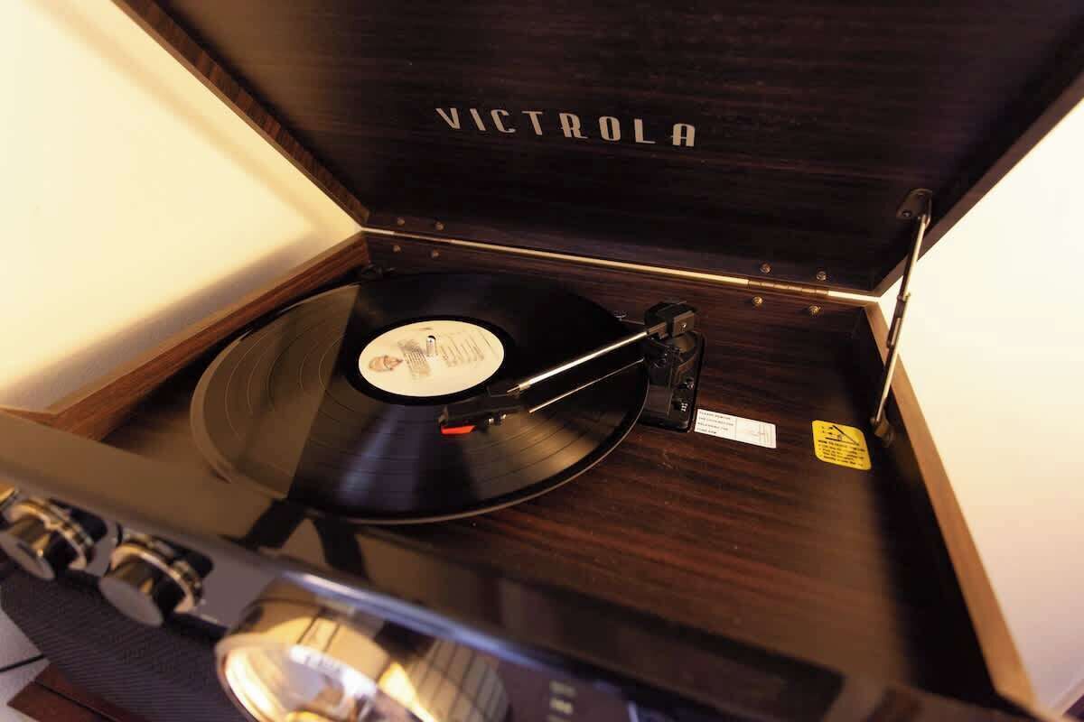 A wooden record player with the brand name 'VICTROLA' on the lid.