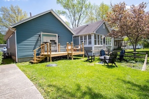 A two-story house with a deck and outdoor seating area.
