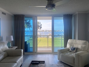 Relax on the balcony with a view of the marina, surrounded by comfortable seating and natural surroundings.