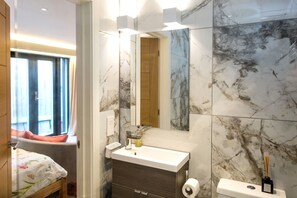 Shower, hair dryer, towels, toilet paper