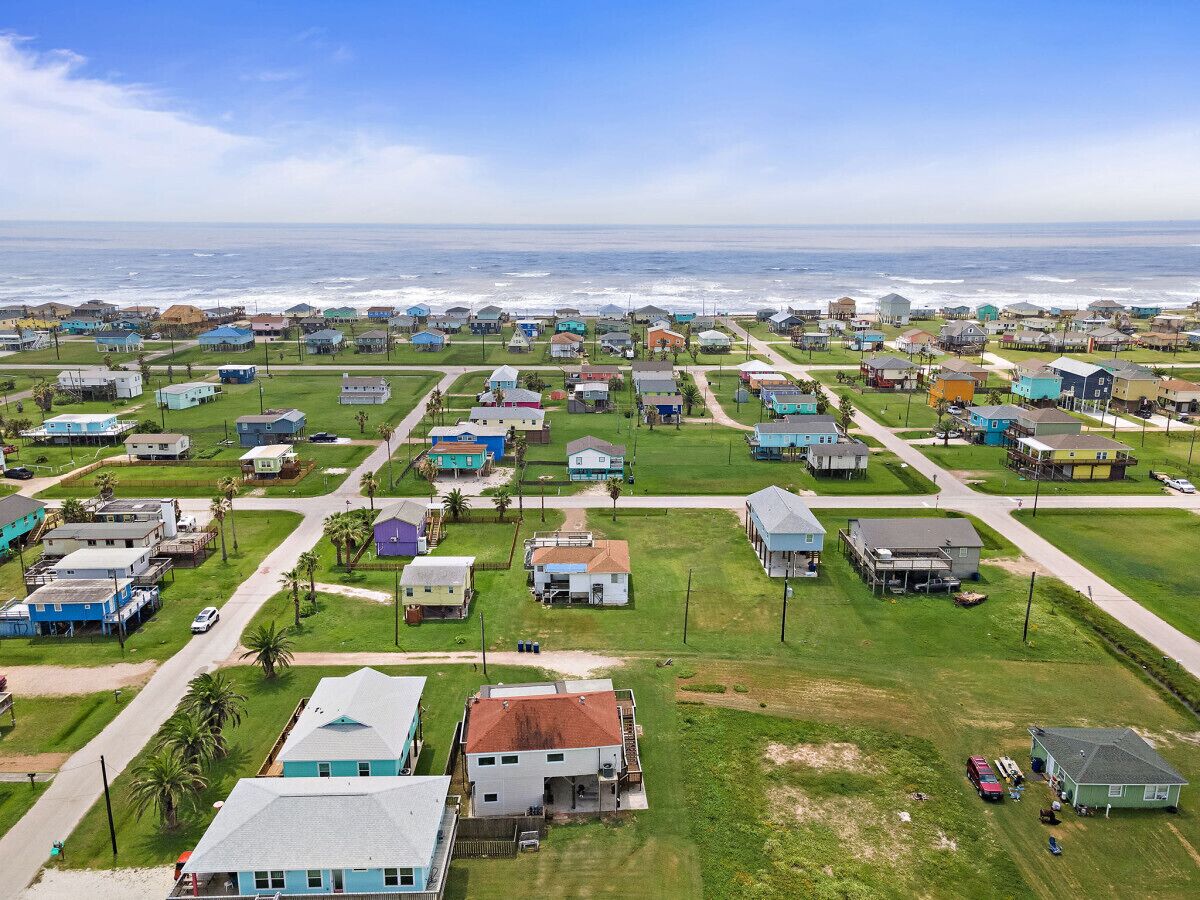 A coastal residential area with houses and a road.