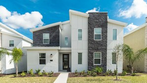 A modern two-story residential building with a flat roof, a central entrance, and a small porch area. - 5 Star Villa Zenith – The Summit of Opulent Living (Orlando)