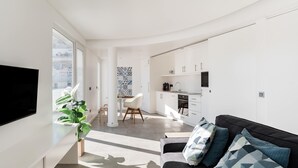 A modern apartment with a living area, kitchen, and dining space. - ☀️ ❤️ Watch Sunsets over the Rooftops at an Old Town Penthouse (Albufeira)