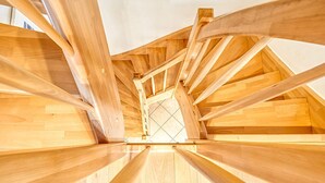 Un escalier en bois avec un motif géométrique sur le sol.