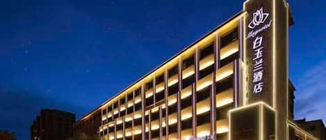 A multi-story hotel with a prominent sign on the facade.