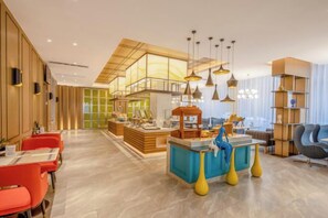 A modern hotel lobby with a central bar area, seating arrangements, and a large window providing natural light. - Magnotel Hotel (Yan'an Baota Mountain Hundred Meter Avenue) (Yan'an)