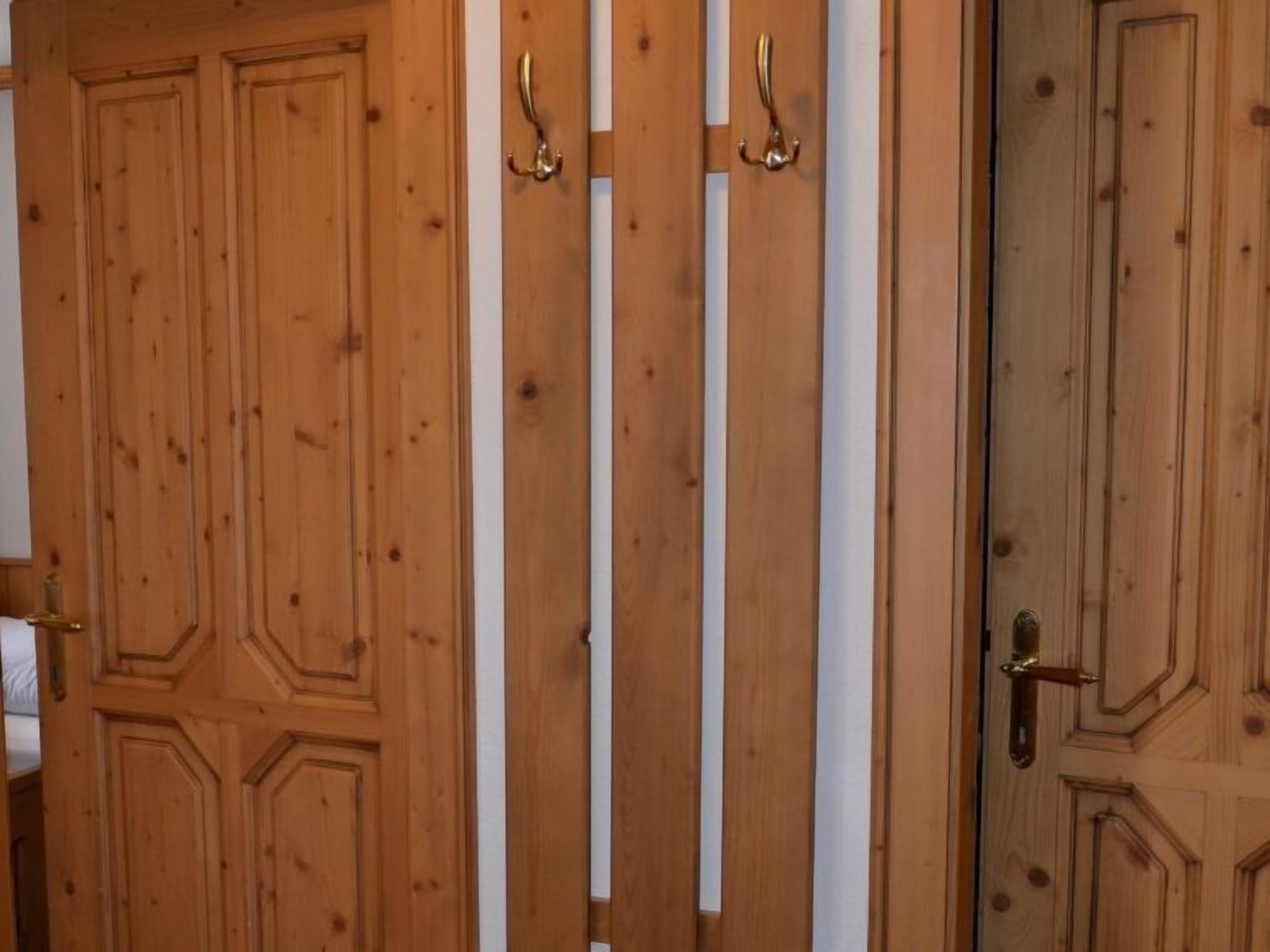 A wooden door with a brass handle and a keyhole.