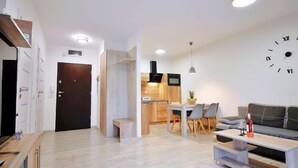 A modern living room with a sofa, coffee table, and dining area. - Apartment A 204 by Interhome (Kolobrzeg)