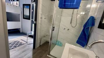 Shower, eco-friendly toiletries, hair dryer, towels